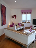 Pink highlights with tooled leather sofas